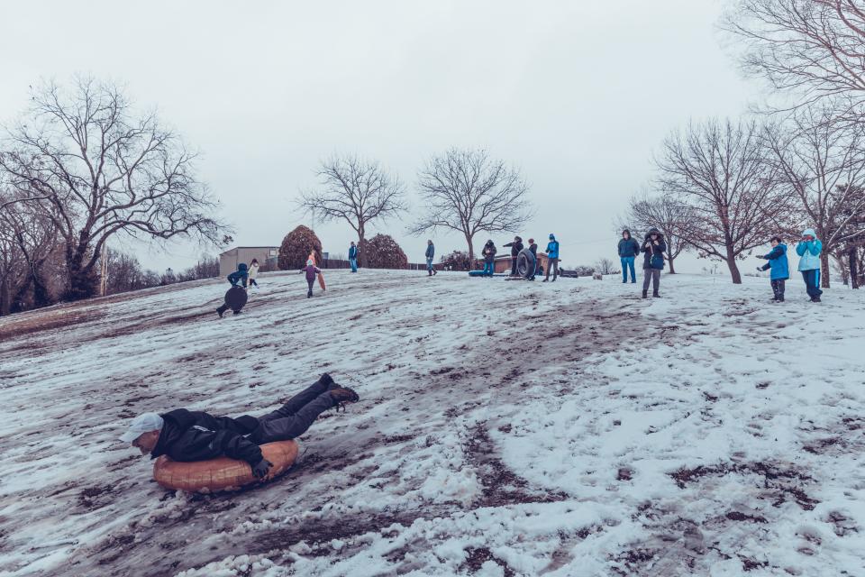 Dennis Waterman takes to the hills as he enjoys the first snow of 2021 with other Bartlesville residents at Sooner Park on Jan. 1, 2021.