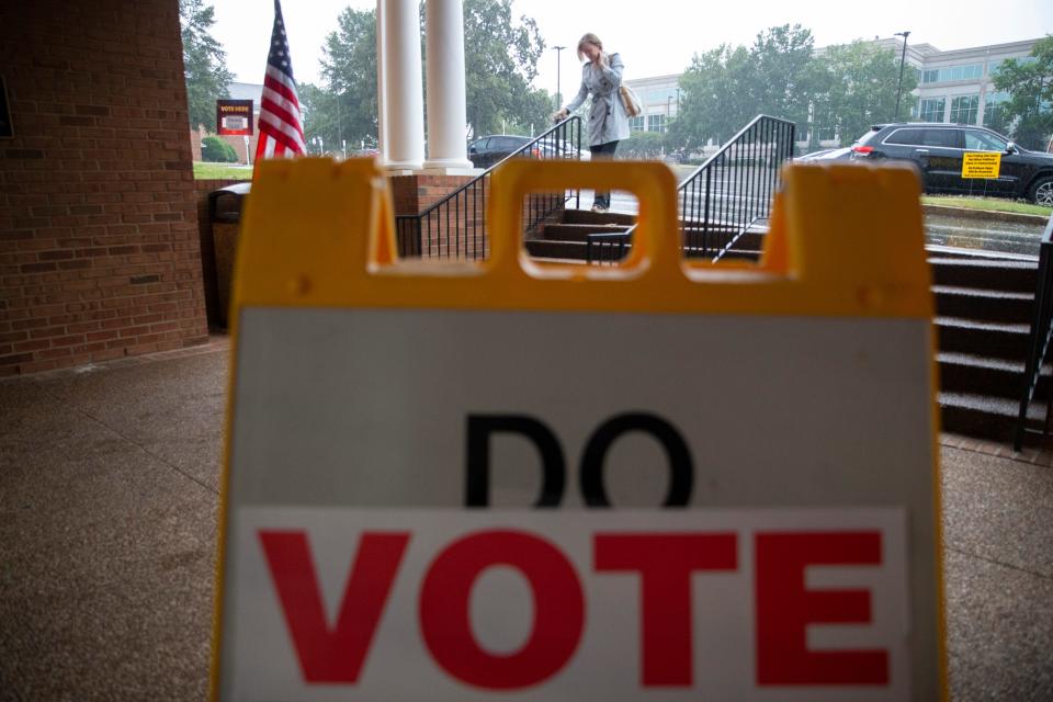 Laura Linder walks through the rain to vote at First Evangelical Church on Election Day in Memphis, Tenn., on Thursday, October 5, 2023. “It’s a civic responsibility,” Linder said on why she came out to vote. “Rain is not going to stop me from coming to vote.”