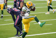 Green Bay Packers running back Jamaal Williams (30) celebrates after running for a gain as Houston Texans cornerback Phillip Gaines (29) is seen in the background during the second half of an NFL football game Sunday, Oct. 25, 2020, in Houston. (AP Photo/Sam Craft)