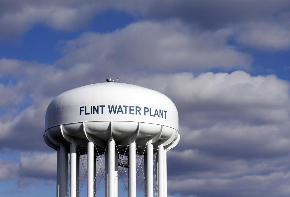 FILE - In this March 21, 2016 file photo, the Flint Water Plant water tower is seen in Flint, Mich. Michigan environmental officials announced Tuesday, Jan. 24, 2017, that Flint's water system no longer has levels of lead exceeding the federal limit. The finding by the Department of Environmental Quality is good news for a city whose 100,000 residents have grappled with the man-made water crisis since 2014. (AP Photo/Carlos Osorio, File)