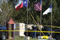 <p>Law enforcement officials stand next to a covered body at the scene of a fatal shooting at the First Baptist Church in Sutherland Springs, Texas, Nov. 5, 2017. (Nick Wagner/Austin American-Statesman via AP) </p>