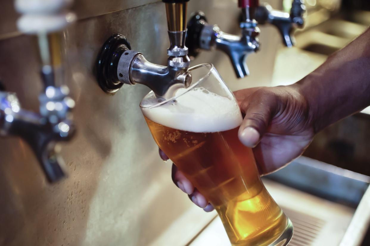 filling glass of beer from tap