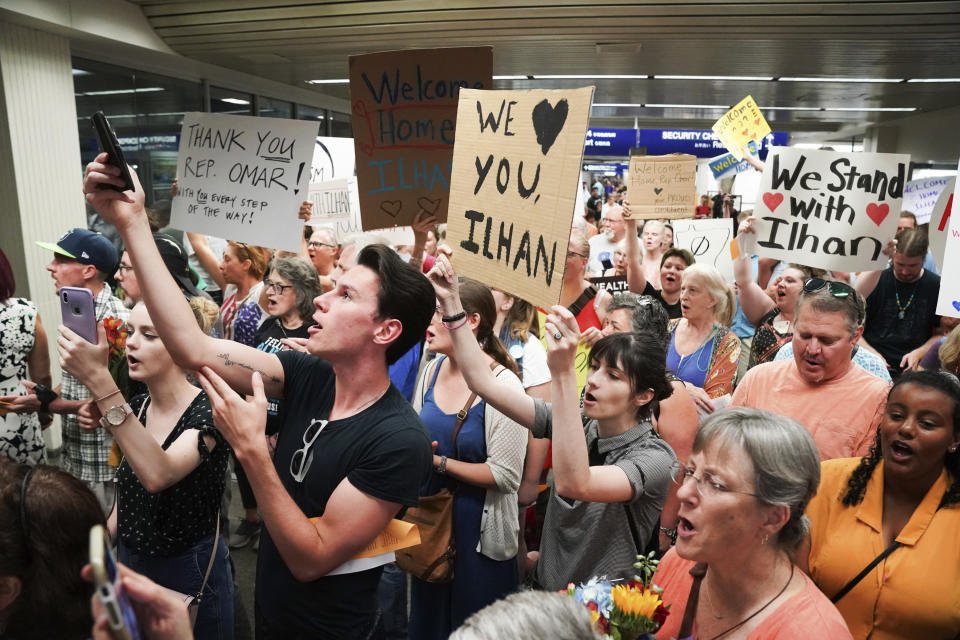 Supporters greet U.S. Rep. Ilhan Omar after she arrived home, at Minneapolis–Saint Paul International Airport, Thursday, July 18, 2019, in Minnesota. President Donald Trump is chiding campaign supporters who'd chanted "send her back" about Somali-born Omar, whose loyalty he's challenged. (Glen Stubbe/Star Tribune via AP)