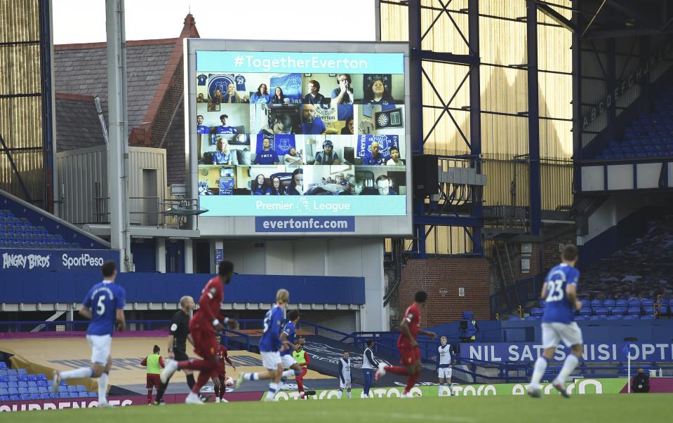 Everton fans are displayed on a large screen as the watch remotely the English Premier League soccer match between Everton and Liverpool at Goodison Park in Liverpool, England, Sunday, June 21, 2020. (Peter Powell/Pool via AP)