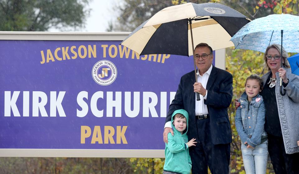 Rain fell as Jackson Township officials met in October 2021 to dedicate Kirk Schuring Park on Belden Green Road NW in honor of state Sen. Kirk Schuring, shown with wife, Darlene, and grandchildren Everett Schuring and Quinn Schuring.