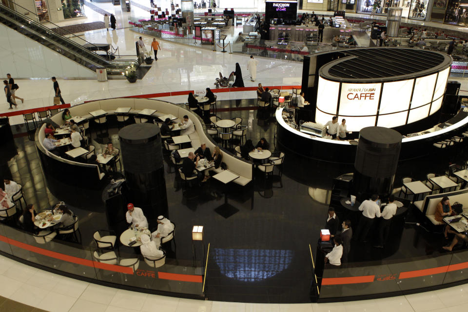 People enjoy their free time at Armani Cafe in Dubai Mall in Dubai, United Arab Emirates, Tuesday, Sept. 25, 2012. Vogue's fashion-loving fans will soon have a chance to drink in the magazine's aura at a new Cafe in Dubai. (AP Photo/Kamran Jebreili)