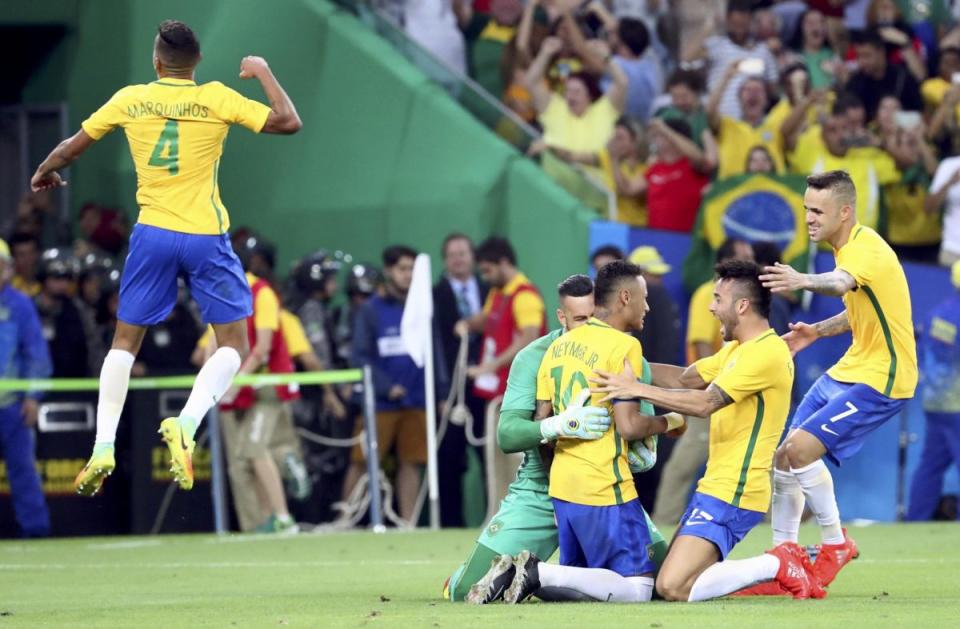 Members of the Brazilian men's soccer team celebrate after beating Germany in a shootout to win Olympic gold on Saturday. (Getty)