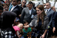 Queen Rania of Jordan (R) caresses a baby from Afghanistan with severe burns, during her visit at the Kara Tepe refugee camp on the Greek island of Lesbos, Greece, April 25, 2016. REUTERS/Alkis Konstantinidis