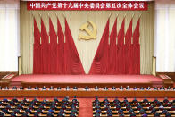 In this photo released by Xinhua News Agency, Chinese President Xi Jinping, center, also general secretary of the Communist Party of China (CPC) Central Committee, leads other Chinese leaders attending the fifth plenary session of the 19th Central Committee of the Communist Party of China (CPC) in Beijing, China on Oct. 29, 2020. China's leaders are vowing to make their country a self-reliant "technology power" after a meeting to draft a development blueprint for the state-dominated economy over the next five years. (Liu Bin/Xinhua via AP)