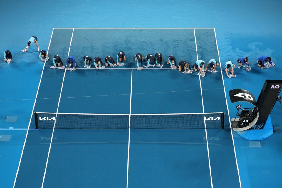 Ball kids and officials dry the court d (Getty Images)