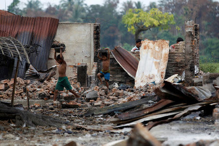 Children recycle goods from the ruins of a market which was set on fire at a Rohingya village outside Maugndaw in Rakhine state, Myanmar, October 27, 2016. REUTERS/Soe Zeya Tun /File Photo