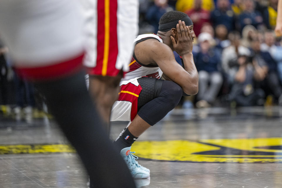 Miami Heat center Bam Adebayo reacts after being called for a foul during the second half of an NBA basketball game against the Indiana Pacers in Indianapolis, Sunday, April 7, 2024. (AP Photo/Doug McSchooler)