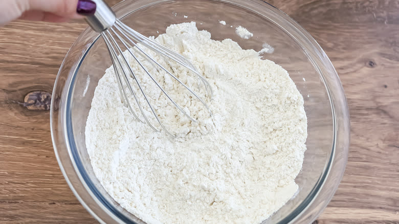 a bowl with dry ingredients and a whisk