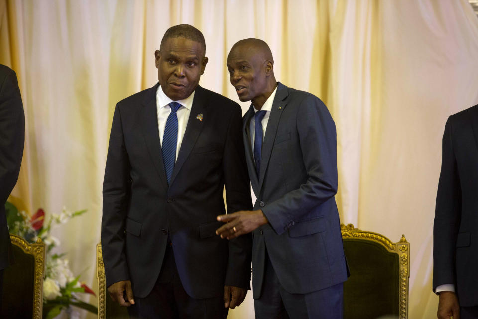 FILE - In this Sept. 17, 2018 file photo, Prime Minister Jean-Henry Ceant, left, and Haiti's President Jovenel Moise, attend the minister's ratification's ceremony at the national palace in Port-au-Prince, Haiti. An American security contractor at the center of a mysterious case roiling Haitian politics says that he and a group of fellow veterans were sent to Haiti on a mission to protect a businessman signing a more than $50 million contract at the country’s central bank. (AP Photo/Dieu Nalio Chery, File)