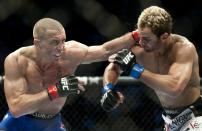 Georges St-Pierre (L) from Montreal, Canada punches Josh Koscheck from Waynesburg US during the third round of the Ultimate Fighting Championship on December 11, 2010 at Bell Centre in Montreal, Quebec, Canada. AFP PHOTO / ROGERIO BARBOSA (Photo credit should read ROGERIO BARBOSA/AFP/Getty Images)