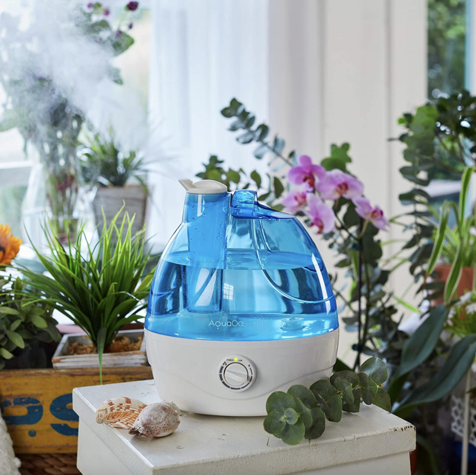 AquaOasis Cool Mist Humidifier on white counter with plants in background (Photo via Amazon)