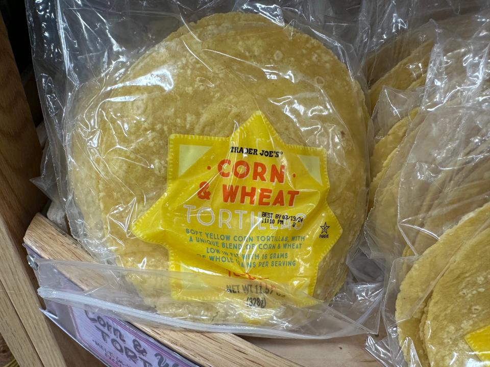 packages of trader joe's corn and wheat tortillas on the shelves