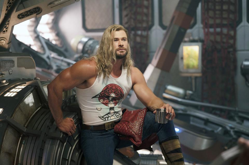 Thor leaning on a piece of machinery