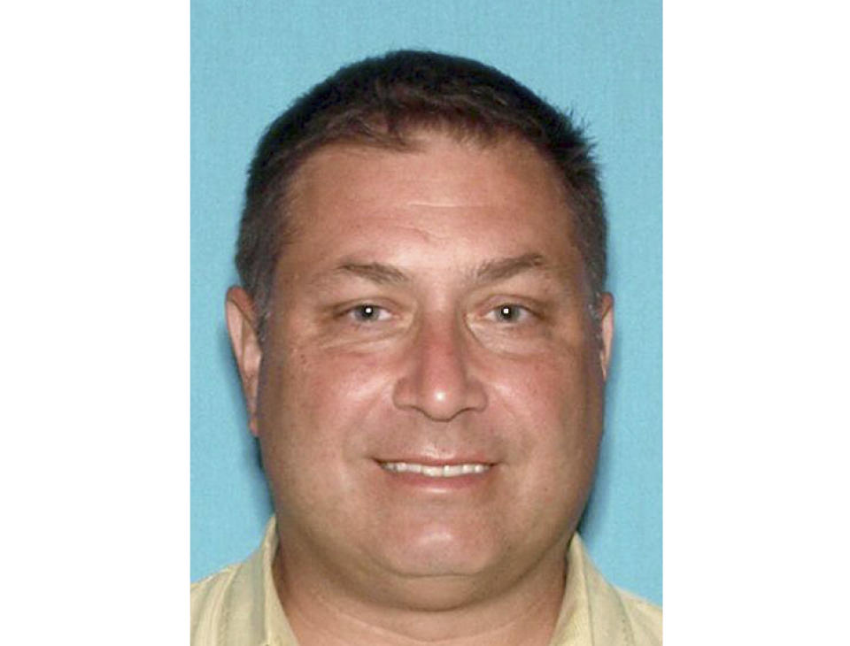 This image released by the Monmouth County Prosecutor's Office, shows Paul Caneiro, who prosecutor charged Wednesday, Nov. 21, 2018, with aggravated arson. He's accused of setting fire to his own home in Ocean Township, N.J. That fire took place early Tuesday morning before authorities responded to a deadly blaze at the Colts Neck mansion owned by Caneiro's brother Keith and Keith's wife, Jennifer.