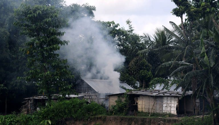 Rioters burn homes in Nelibari village in Assam state's Chirang District in July. Around 1,000 workers at the privately-owned M.K.B. Tea Estate attacked the plantation owner's bungalow on Wednesday and set it on fire in violence blamed on festering labour unrest in the tea-growing region, police said