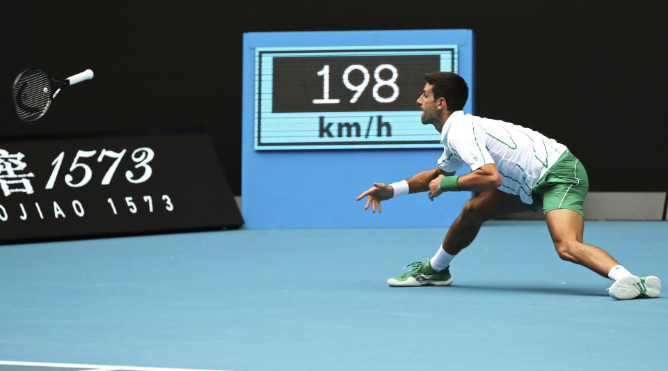 Serbia's Novak Djokovic throws his racket at the ball during his second round match against Japan's Tatsuma Ito at the Australian Open tennis championship in Melbourne, Australia, Wednesday, Jan. 22, 2020. (AP Photo/Dita Alangkara)