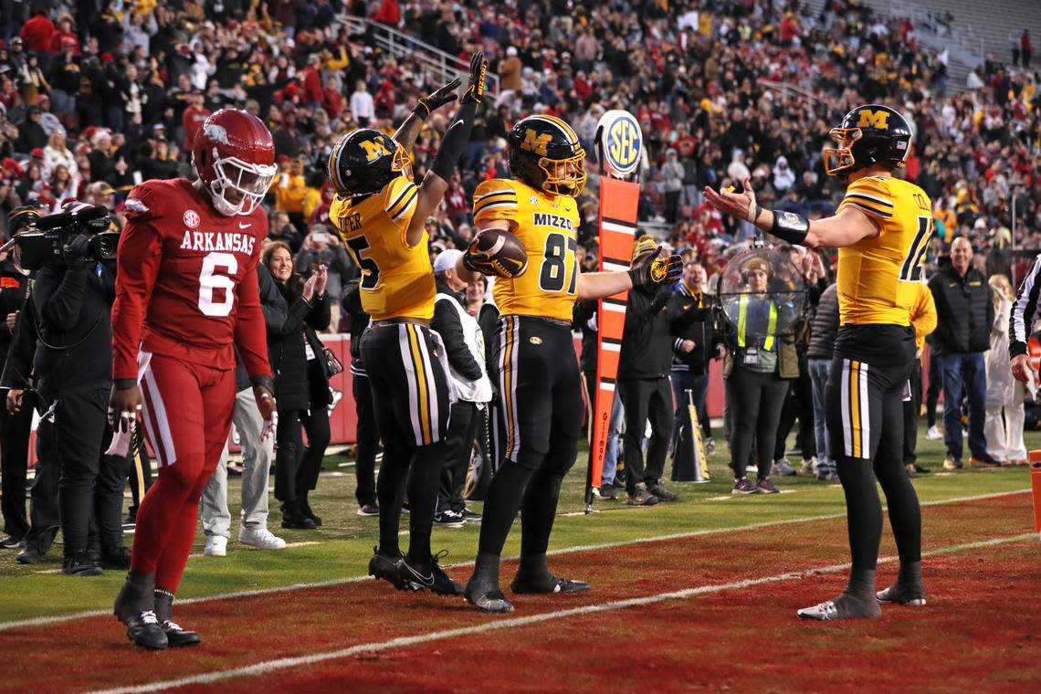 Missouri tight end Brett Norfleet (No. 87) celebrates one of his two touchdown receptions from Tigers quarterback Brady Cook (No. 12) during Friday’s game against the Arkansas Razorbacks at Donald W. Reynolds Razorback Stadium in Fayetteville, Ark.