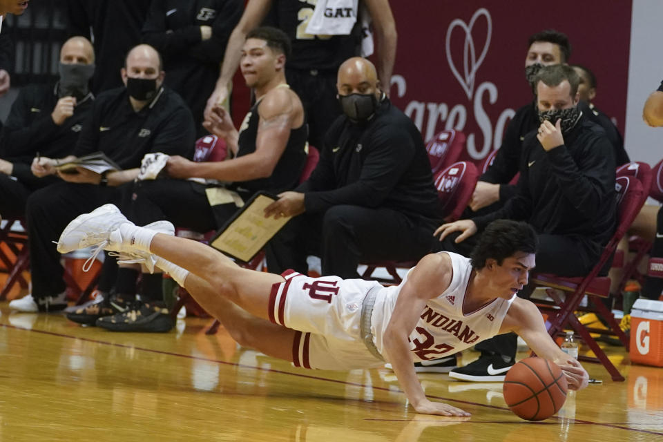 Indiana's Trey Galloway (32) dives for a loose ball during the second half of an NCAA college basketball game against Purdue, Thursday, Jan. 14, 2021, in Bloomington Ind. Purdue won 81-69. (AP Photo/Darron Cummings)