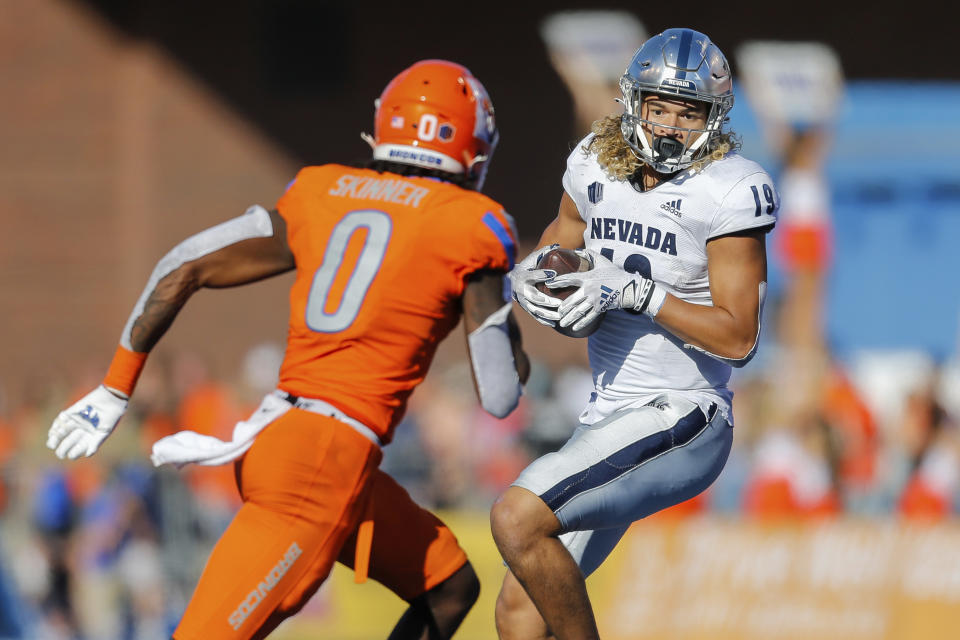 Nevada tight end Cole Turner (19) turns after a reception in front of Boise State safety JL Skinner (0) in the second half of an NCAA college football game Saturday, Oct. 2, 2021, in Boise, Idaho. (AP Photo/Steve Conner)