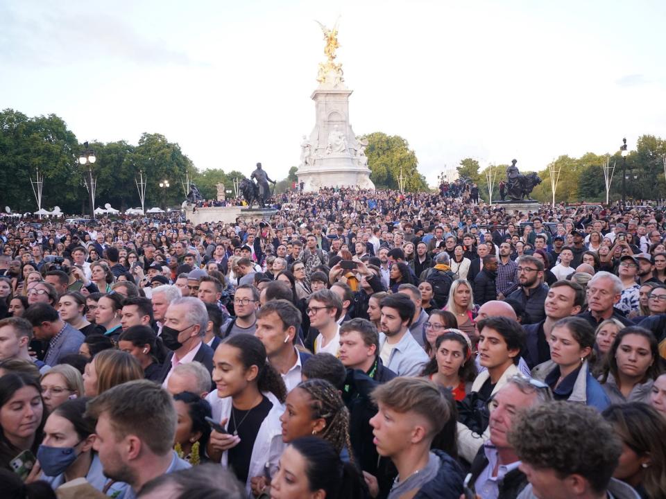 A crowd gathers at Buckingham Palace following Queen Elizabeth II's death.