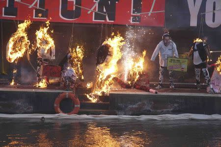 A collection of punk memorabilia belonging to Joe Corre, the son of Malcolm McLaren, the former manager of the Sex Pistols and fashion designer Vivienne Westwood, is burnt on a boat on the River Thames, in London, Britain November 26, 2016. REUTERS/Neil Hall