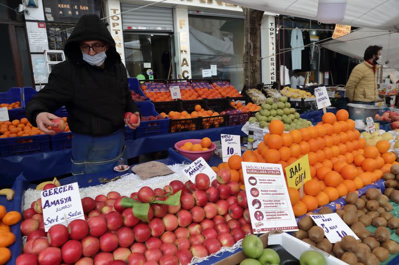 Geyik waits for customers at his stall at a local market in Fatih district in Istanbul