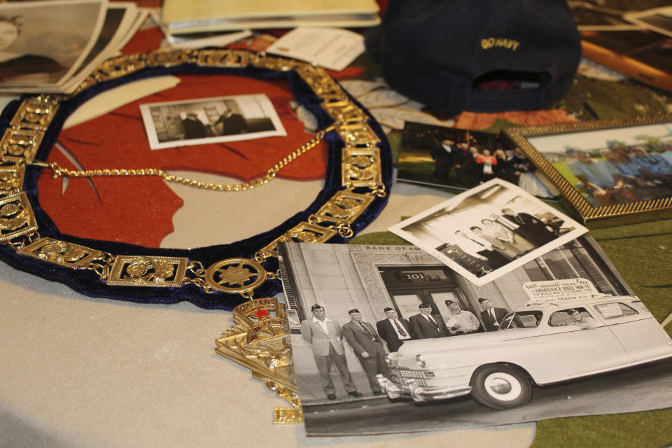 U.S. Navy memorabilia and old photographs of Ira "Ike" Schab, 103, are displayed on the kitchen table in his home in Beaverton, Ore. on Monday, Nov. 20, 2023. Schab was in the Navy and on the USS Dobbin during the Pearl Harbor attacks on Dec. 7, 1941. Eighty-two years later, Schab plans to return to Pearl Harbor on the anniversary of the attack to remember the more than 2,300 servicemen killed. (AP Photo/Claire Rush)