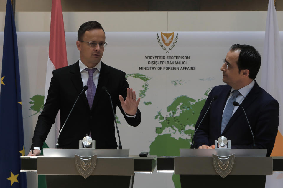 Hungarian Minister of Foreign Affairs and Trade Peter Szijjarto, left, and Cyprus' Foreign Minister Nikos Christodoulides speak during a news conference at the Cypriot foreign ministry on Friday, June 26, 2020. Szijjarto is in Cyprus for one-day visit. (AP Photo/Petros Karadjias)