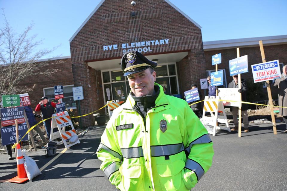 Rye police chief Kevin Walsh stands outside the Rye polls Tuesday, March 12, 2024 as a steady flow of voters arrive and depart.