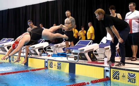 Prince Harry cheers on British swimmers at the Toronto Pan Am Sports Centre