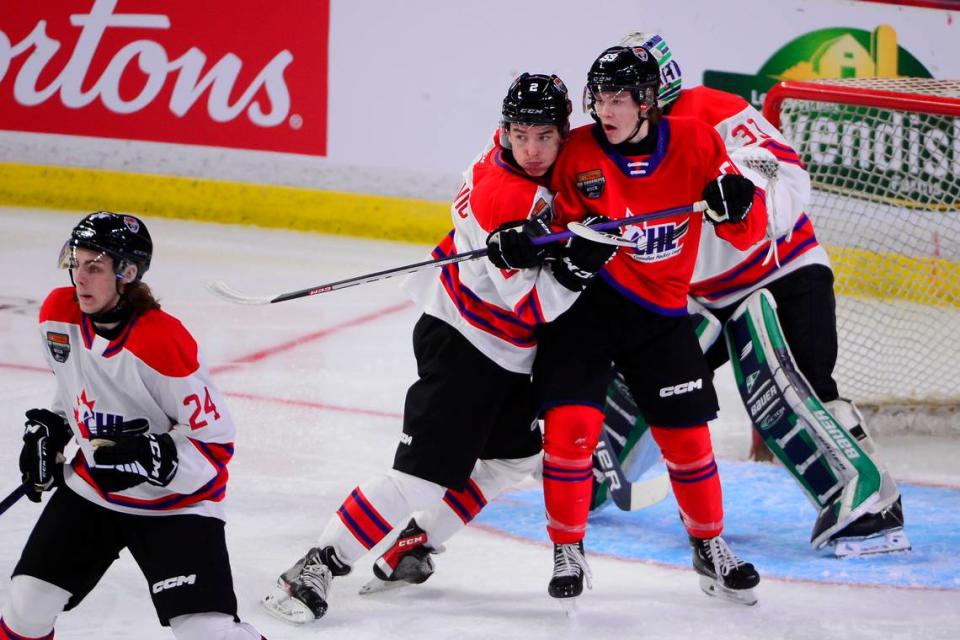 Jan 25, 2023; Langley, BC, CANADA; CHL Top Prospects team white defenseman Lukas Dragicevic (2) defends against CHL Top Prospects team red forward Gracyn Sawchyn (59) during the first period in the 2023 CHL Top Prospects ice hockey game at Langley Events Centre. Mandatory Credit: Anne-Marie Sorvin-USA TODAY Sports