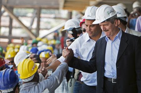 Workers greet Brazil's former World Cup winner Ronaldo, who is on the 2014 local organising committee, and Brazil's Sports Minister Aldo Rebelo (R) during a visit by FIFA Secretary General Jerome Valcke to the Arena Pantanal stadium in Cuiaba October 8, 2013. REUTERS/Jose Medeiros