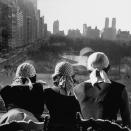 <p>A group of women stare out of a window overlooking New York City's Central Park in 1952. </p>