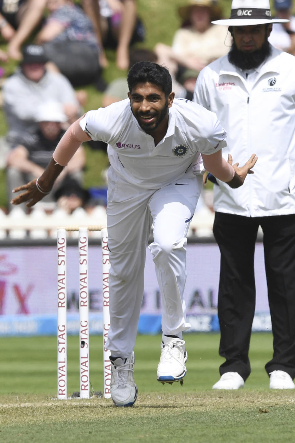 India's Jasprit Bumrah runs through after bowling against New Zealand during the first cricket test between India and New Zealand at the Basin Reserve in Wellington, New Zealand, Saturday, Feb. 22, 2020. (AP Photo/Ross Setford)