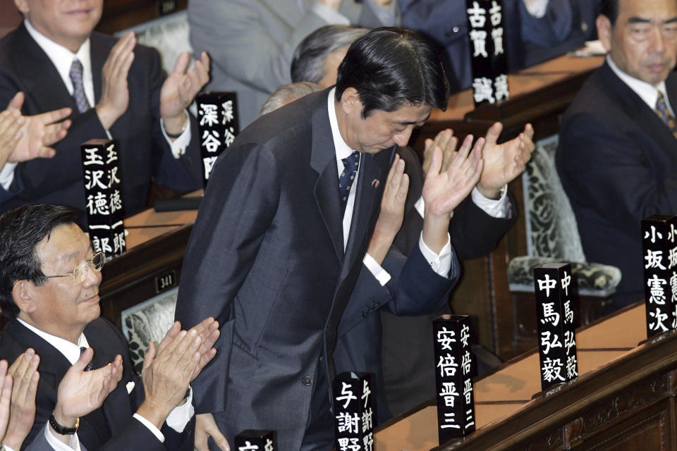 FILE - Shinzo Abe, president of the ruling Liberal Democratic Party, bows at the House of Representatives after being elected as Japan's new prime minister in Tokyo on Sept. 26, 2006. In 2006, Abe became Japan’s prime minister for the first time, overseeing economic reforms while taking a hard line on North Korea and seeking to engage with South Korea and China. (AP Photo/Katsumi Kasahara, File)