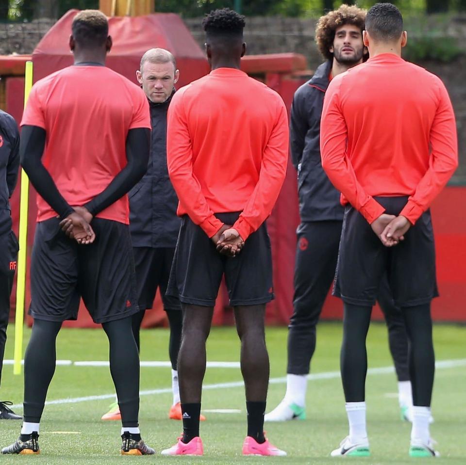  The Manchester United squad hold a minute's silence in honour of the victims of the attack at Manchester Arena ahead of a first team training session, ahead of the UEFA Europa League Final - Credit: John Peters/Man Utd/Getty