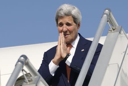 U.S. Secretary of State John Kerry gives the traditional Indian greeting before departing India at the airport in Ahmedabad January 12, 2015. REUTERS/Rick Wilking