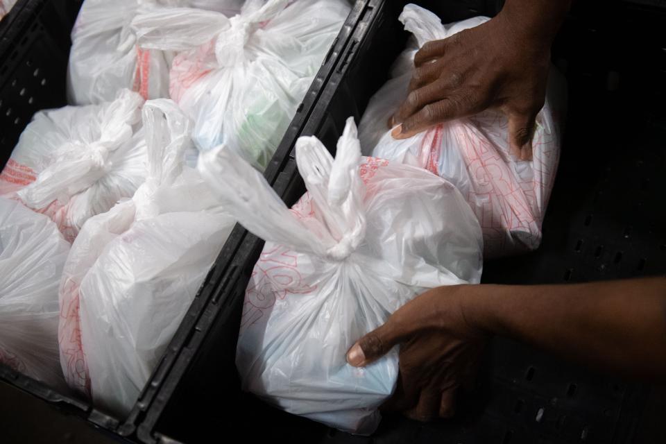 Volunteer Karl Fortson places "backpack" meals specifically for children in containers at the Tri-State Food Bank in Evansville, Ind., Wednesday morning, June 22, 2022.