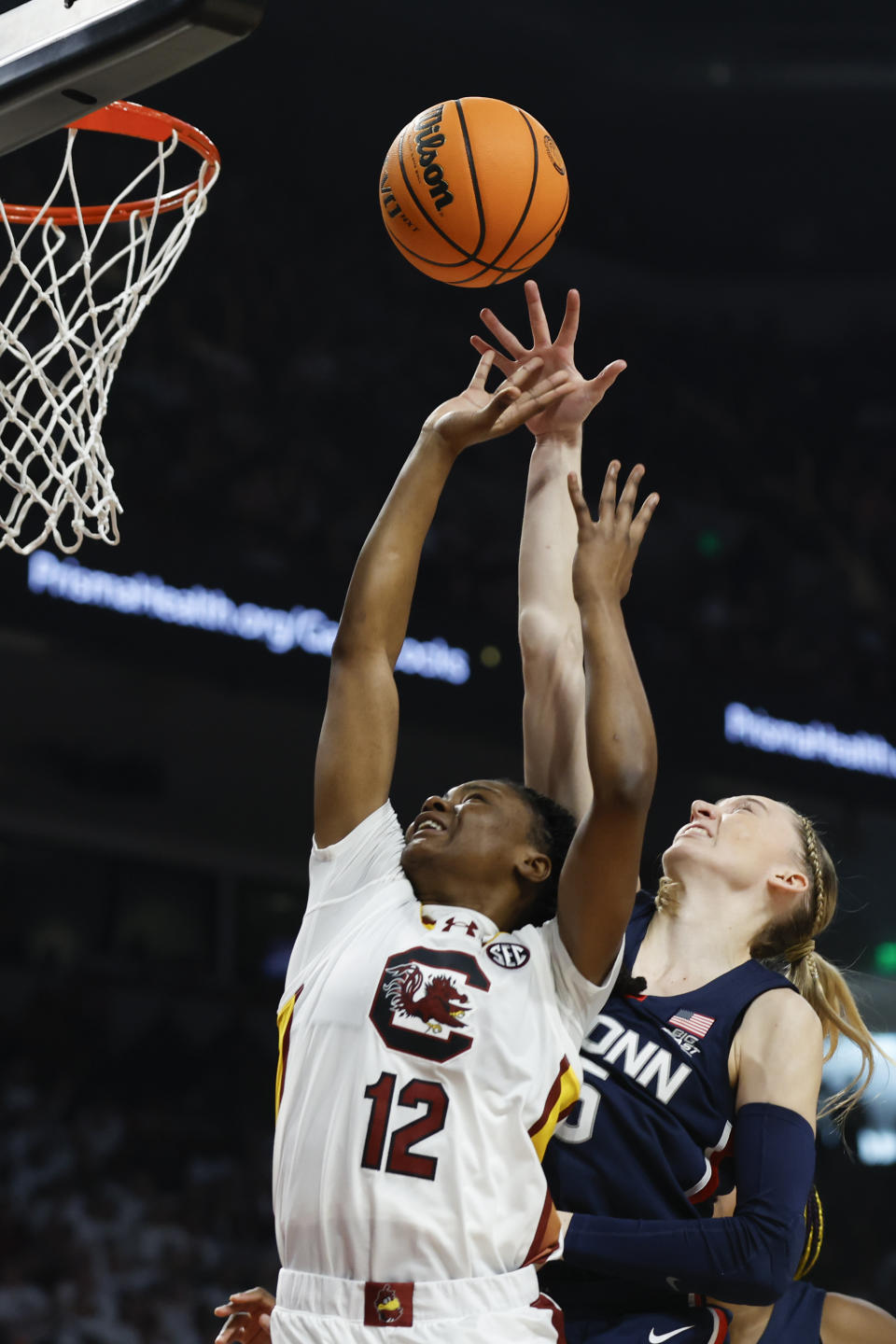 South Carolina guard MiLaysia Fulwiley (12) shoots against UConn guard Paige Bueckers, right, during the first half of an NCAA college basketball game in Columbia, S.C., Sunday, Feb. 11, 2024. (AP Photo/Nell Redmond)