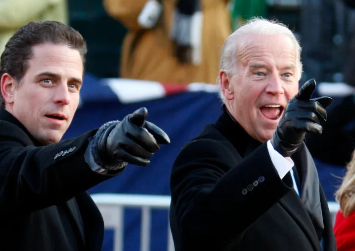 Then-Vice President Joe Biden (R) points to some faces in the crowd with his son Hunter Biden as they walk down Pennsylvania Avenue following the inauguration ceremony of President Barack Obama in Washington, DC, on January 20, 2009.