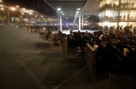 Protesters form barricades as they demonstrate at the airport, after a verdict in a trial over a banned independence referendum, in Barcelona