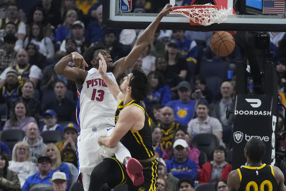 Detroit Pistons center James Wiseman, left, is fouled while dunking against Golden State Warriors forward Dario Saric during the first half of an NBA basketball game in San Francisco, Friday, Jan. 5, 2024. (AP Photo/Jeff Chiu)
