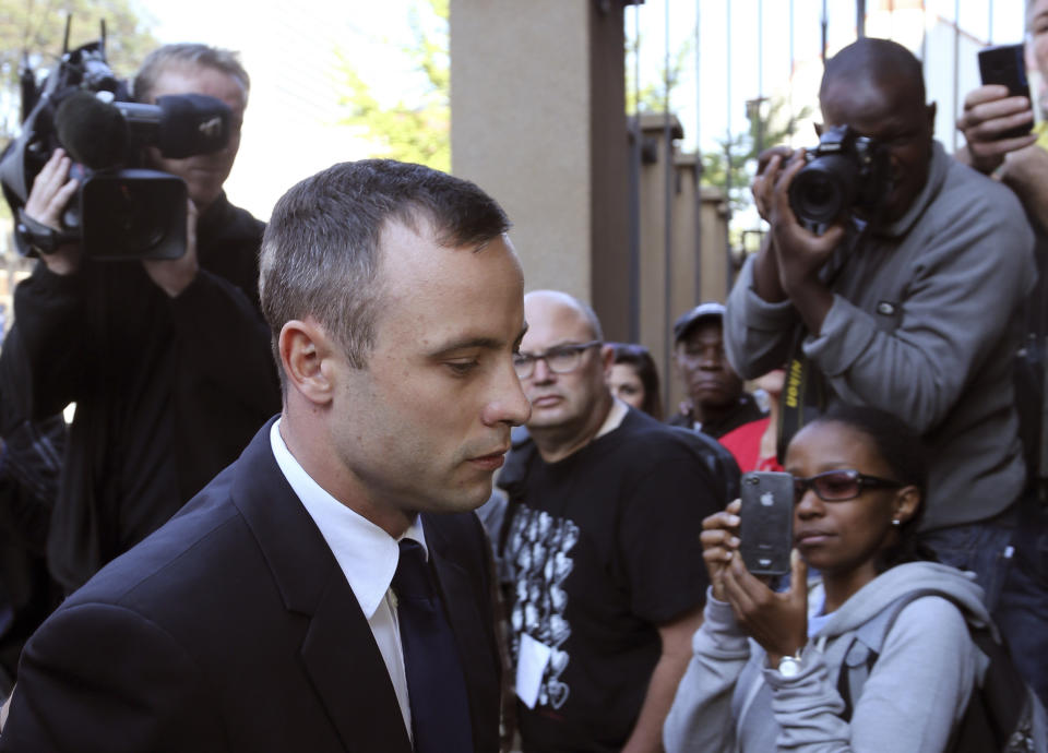 Oscar Pistorius, arrives at the high court in Pretoria, South Africa, Tuesday, April 15, 2014. Pistorius, who is charged with murder for the shooting death of his girlfriend, Reeva Steenkamp, on Valentine's Day in 2013, has resumed testifying at his trial under questioning from the chief prosecutor, who says the athlete's statement that he killed Steenkamp by mistake is a lie. (AP Photo/Themba Hadebe)