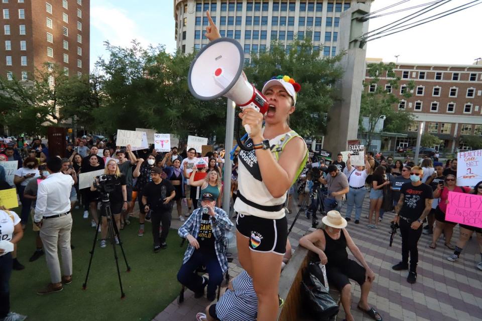 Erika Latines of El Paso yells into a megaphone as she speaks to a crowd that turned out to protest the U.S. Supreme Court’s decision to overturn Roe v. Wade on Friday evening, June 24, 2022, at San Jacinto Plaza in Downtown El Paso.