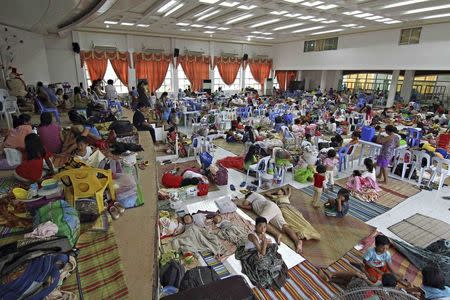 People take shelter inside a evacuation centre after evacuating from their homes due to super-typhoon Hagupit in Surigao city, southern Philippines December 5, 2014. REUTERS/Stringer